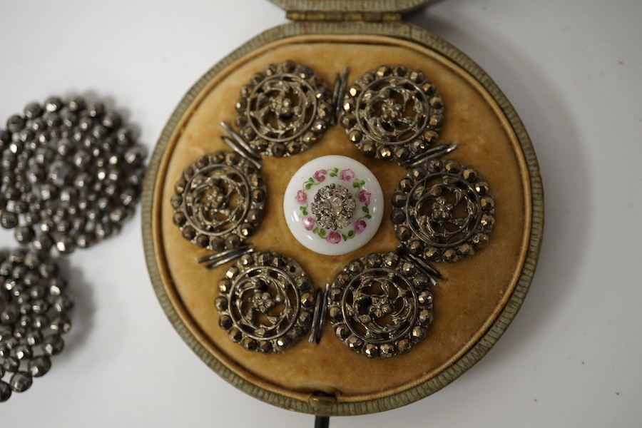 An Edwardian cased set of 6 cut steel buttons with central floral motifs, 20mm, a paste inset ceramic button, a set of 4 cut steel buttons, 33mm and a set of 5 cut steel and simulated turquoise buttons, 33mm. Condition -